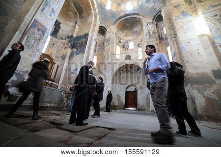 VAN,TURKEY-APRIL 28: Unidentified tourists visiting the Akdamar Church.Armenian Church of the Holy Cross stands on Akhtamar Island (Akdamar) in Lake Van on April 28,2015 in Van,Turkey.