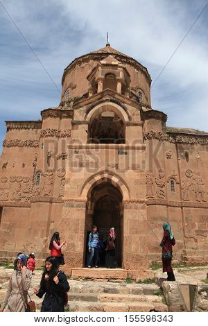 VAN,TURKEY-APRIL 28: Unidentified tourists visiting the Akdamar Church.Armenian Church of the Holy Cross stands on Akhtamar Island (Akdamar) in Lake Van on April 28,2015 in Van,Turkey.