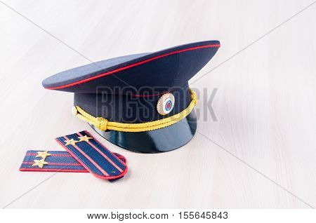 Cap and epaulets of lieutenant colonel are on the table