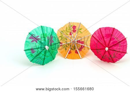 Close up colorful of many cocktail umbrellas on white background