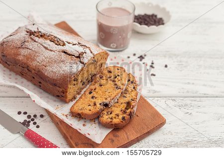 Homemade pumpkin cake with chocolate on wooden background. 