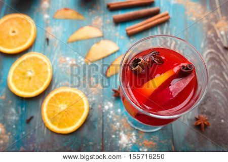 Orange, apple, cinnamom, anice, wine (mulled wine) on wooden background