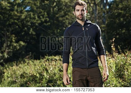 Portrait of handsome guy in park outdoors
