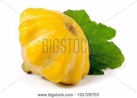 one yellow pattypan squash with leaf isolated on white background.