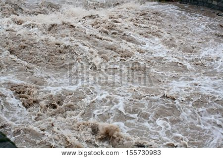 Dirty high water flow in the river after heavy rains, natural disaster