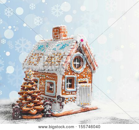 Assorted Christmas gingerbread cookies. Christmas gingerbread village house tree. Christmas New Year's background with snowflakes. Christmas card with gingerbread house Christmas tree reindeer Santa Claus