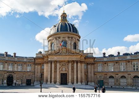 PARIS, FRANCE -circa april, 2016: Pedestrians cross to Bibliotheque Mazarine in Paris.
