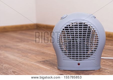 Portable electric heater fan type is on the floor