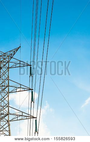 half of High voltage transmission lines isolated on blue sky background
