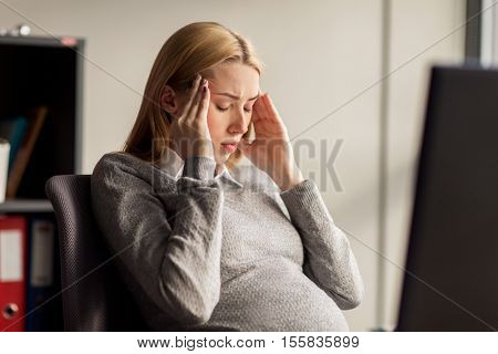 pregnancy, business, stress, gestosis and people concept - pregnant businesswoman feeling sick or suffering from headache at office work
