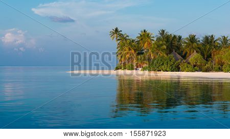 Panorama of a tropical island with a white sand beach and turquoise water of the ocean. Landscape l with palm trees.
