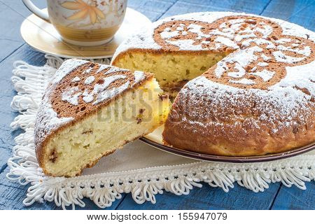 Baking in multicooker. Delicious homemade cake with cottage cheese and chocolate pieces on blue wooden table. Selective focus