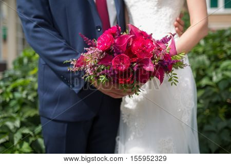 Wedding. Beautiful Weding Bouquet Of Different Flowers In The Hands Of The Bride In A White Wedding 