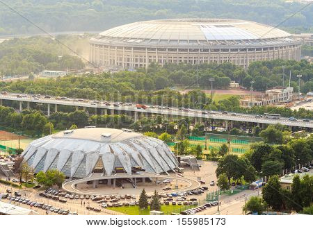 Moscow, Russia - June 20, 2016: Reconstruction of Luzhniki Stadium and Druzhba Multipurpose Arena for soccer world cup 2018 in Luzhniki, Moscow. Bridge Luzhniki, transportation, heavy traffic, cars, parking spaces (view from above) in Moscow, Russia