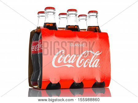 LONDON UK - NOVEMBER 07 2016: Classic bottles Of Coca-Cola six pack on white background
