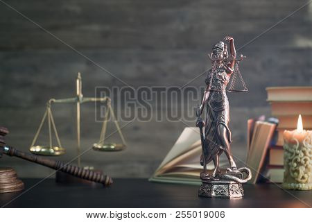 Temida And Wooden Gavel On Wood Background.