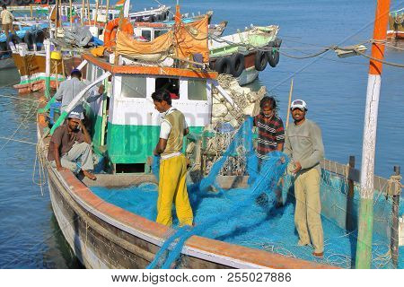 Dwarka, Gujarat, India - December 26, 2013: Fishermen Working On Their Fishing Net In Bet Dwarka Isl