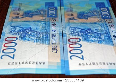 Russian Two Thousandth Notes Close-up Against The Background Of A Dark Wooden Table