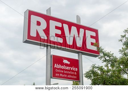 Berlin, German - August 15, 2018: Commercial Sign Of Rewe Store At Cloudy Day.
