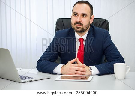 Businessman In  Suit And Red Tie Listens Carefully To His Interlocutor