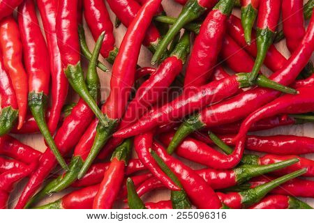 Fresh Red Hot Thai Chili Peppers On Wooden Surface