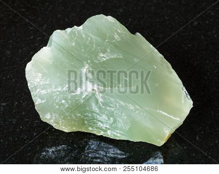 Macro Shooting Of Natural Mineral - Rough Prase (green Quartz) Stone On Black Granite From Ural Moun