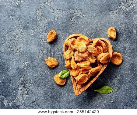 Dried Apricots On Gray Concrete Background With Copy Space. Top View.