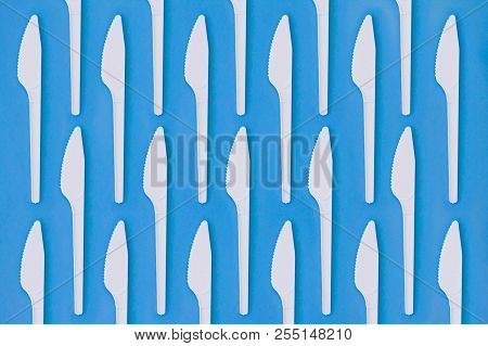 Flay Lay Photo Of White Plastic Disposable Knives. Creative Top View Pattern. Calm Clear Colours.
