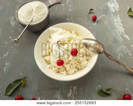 Cottage Cheese In A Bowl, Replaced In A Kremanka, A Spoon. Ripe Cherries