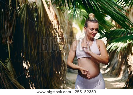 Young Attractive Blond Woman In White Sportswear Doing Yoga Pilates Fitness Exercises In Tropical Na