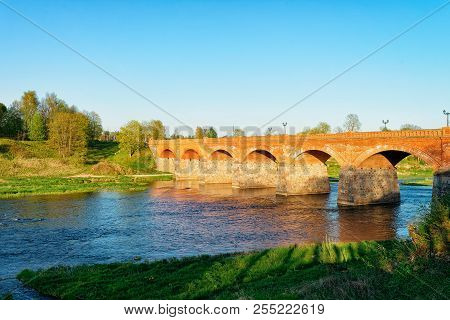 Bridge At Ventas Rumba Waterfall In Kuldiga In Kurzeme In Western Latvia. The City Used To Be Called