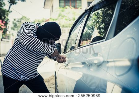 Thief Is Trying To Open A Car With A Screwdriver, Asset Safety.