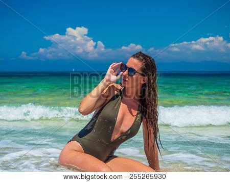 woman sunbathing on the beach summer travel holidays