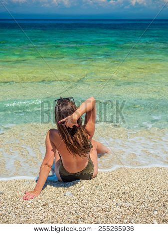 woman sunbathing on the beach summer travel holidays
