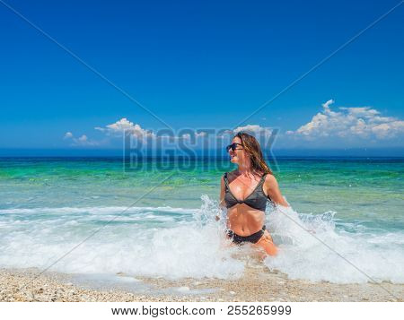 woman sunbathing on the beach summer travel holidays