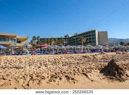 Malia, Crete, Greece - July 1, 2018: People Are Resting On A Sunny Day At The Beach In Malia, Crete,