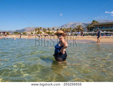 Malia. Crete, Greece - July 1, 2018: People Are Resting On A Sunny Day At The Beach In Malia, Crete,