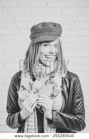 Girl With Orange Leaves At Brick Wall. Beauty And Fashion. Season And Autumn Holiday. Woman With Aut
