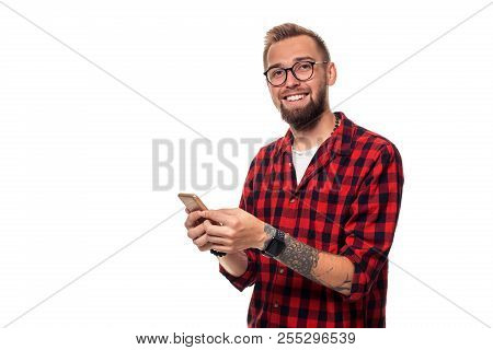 Message To Friend. Handsome Young Man Using Phone With Smile While Standing Againstwhite Background