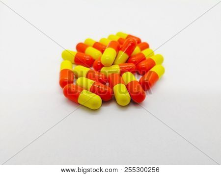 Medication And Healthcare Concept. Many Orange-yellow Capsules Of Tetracycline 250 Mg. Isolated On W