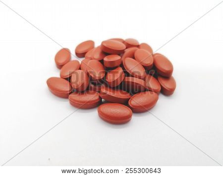 Medication And Healthcare Concept. Many Oval Brown Tablets Of Ferrous Sulfate 300 Mg. With Other Vit