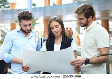Group Of Young Modern People In Smart Casual Wear Having A Brainstorm Meeting While Standing In The 