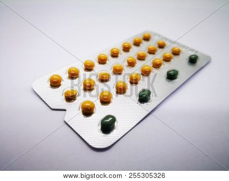Medication And Healthcare Concept. Oral Contraceptive Drug. 24 Yellow Pills Consist Of Ethinyl Estra