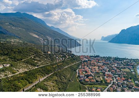 Aerial View On Nago Torbole City And Sarca River.