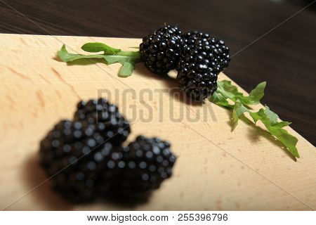 Blackberry And Arugula Laid Out On A Wooden Board Close-up