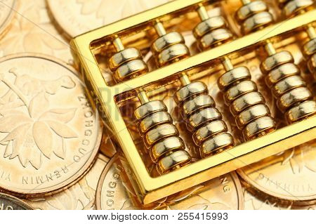 Golden Abacus With Chinese Rmb Gold Coins As Background