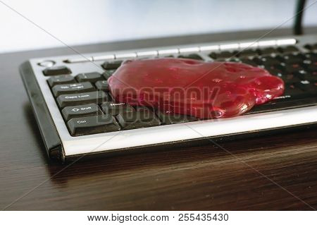 Keyboard Cleaning Gel Is Laying On The Notebook.