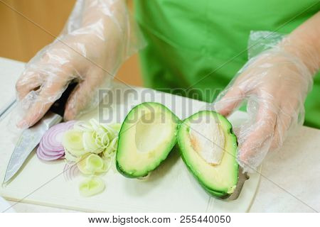 Cook Cuts Avocado For Salad, Stock Photo Image