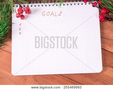 Notepad For Writing Resolution And Goals For The New Year, Spruce Branches On A Wooden Background Wi