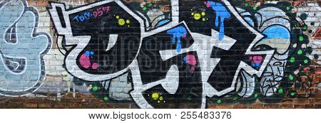 Full And Acomplished Graffiti Artwork. The Old Wall Decorated With Paint Stains In The Style Of Stre